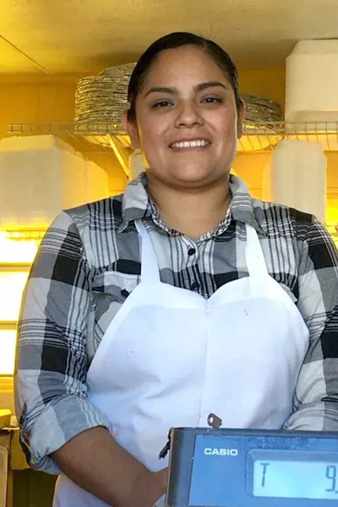 Isabel Castillo smiles from her taco truck, El Amigazo, located on Highway 97 opposite Safeway in Redmond. Her family members work at least 11 hours a day to make their new business thrive. - DENISE HOLLEY