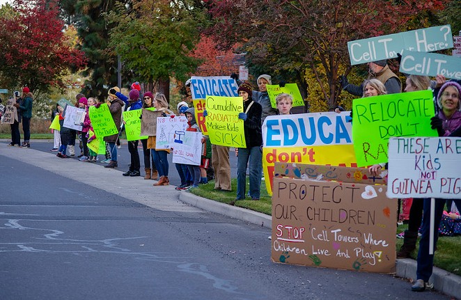 Parents and students from Elk Meadow Elementary School demonstrate outside of the Bend Parks & Recreation District office on Oct. 17, 2019 before a town hall meeting with representatives from Verizon Wireless. - BRIANNA PORTEOUS