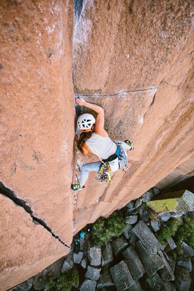 Rock climber Lizzy VanPatten scales the side of a cliff. - NICOLE WASKO