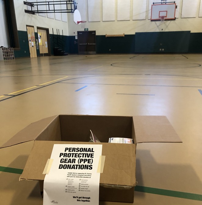 A box sits ready for donations Friday in the gym/cafeteria of Ensworth Elementary in Bend. Drop locations are located at grab-and-go lunch sites around Central Oregon. - NICOLE VULCAN