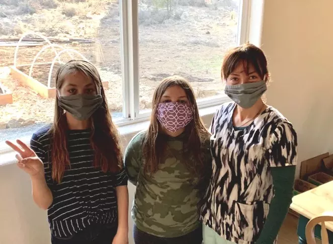 The author's two daughters and wife, wearing the "new normal" garb. - JOSHUA SAVAGE