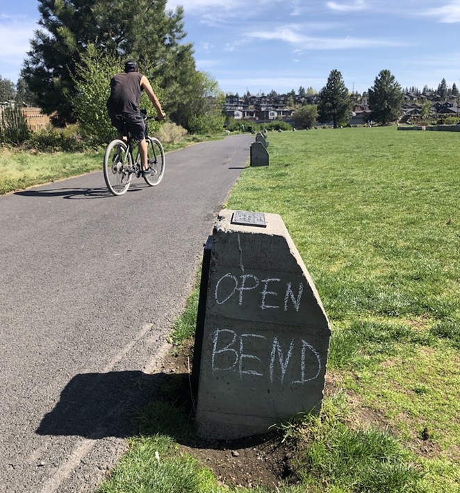On May 7, 2020 a biker rides past Riverbend Park. Six weeks into the statewide lockdown, some locals protest the stay-home order through public demonstrations, social media gripes or a little old school graffiti. - AARON SWITZER