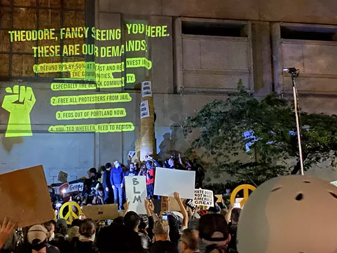 A list of demands for Portland Mayor Ted Wheeler on the exterior of the Multnomah County Justice Center July 22. - NICOLE VULCAN