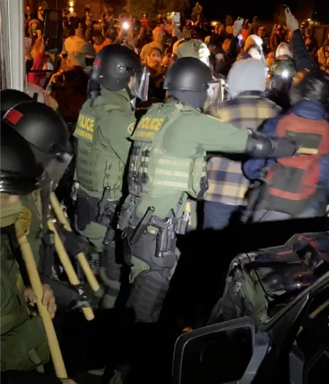 In the middle of the melee Wednesday night, as federal agents extracted a driver and two detainees from the ICE bus. - NICOLE VULCAN