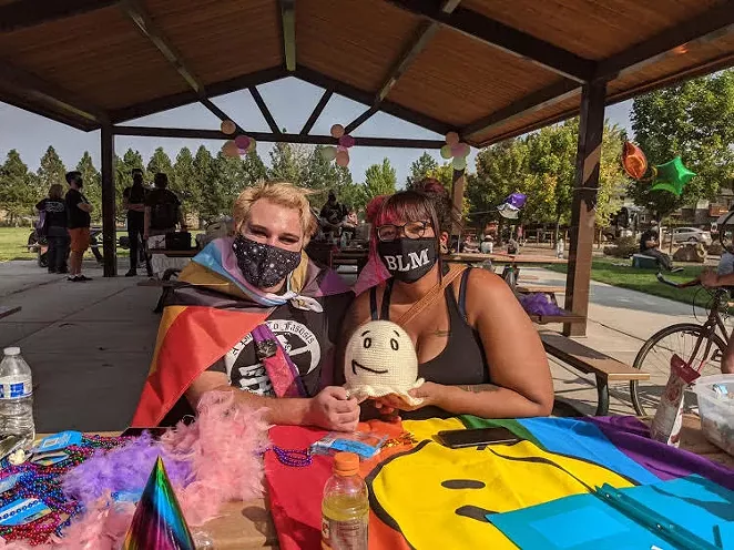 Activists create masks at a crafts table in Pilot Butte Neighborhood Park. - KERSTIN ARIAS