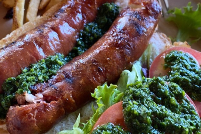 A Bangers &amp; Brews sausage with the famous chimichurri sauce. - COURTESY BANGERS &amp; BREWS