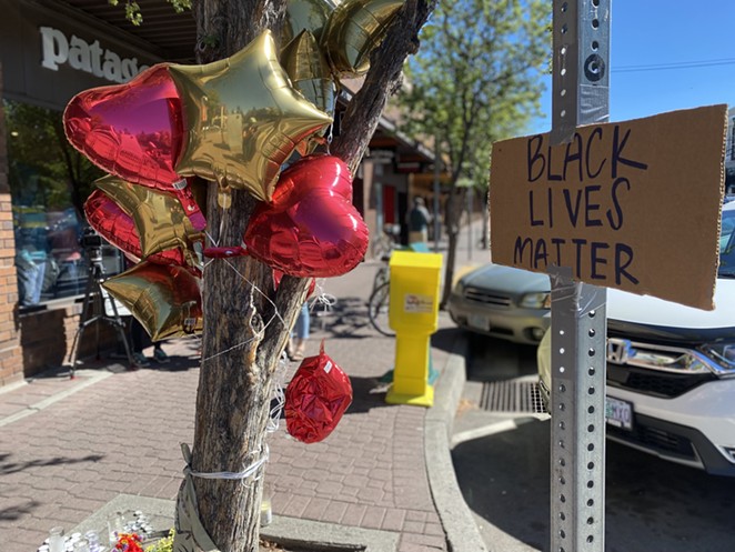 A memorial outside the Patagonia store on Wall St. and Oregon Ave. began to take shape soon after the shooting. - NICOLE VULCAN