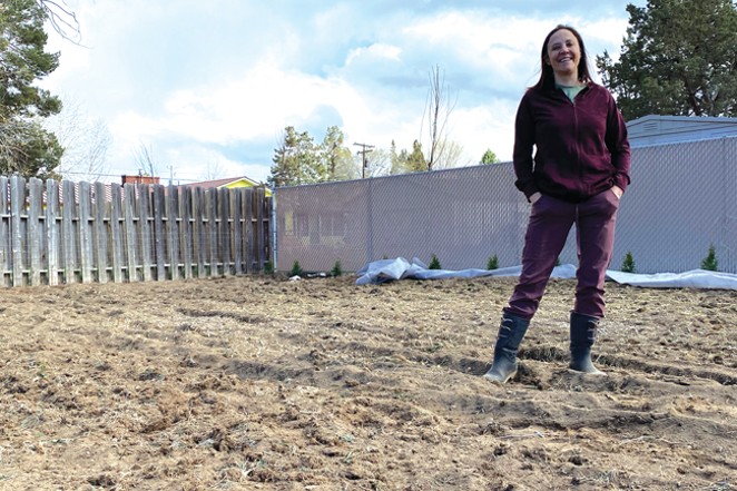 Redmond resident Jess Joseph stands in the middle of her backyard transition from water-sucking grass to a more natural landscape. - CREDIT NICOLE VULCAN
