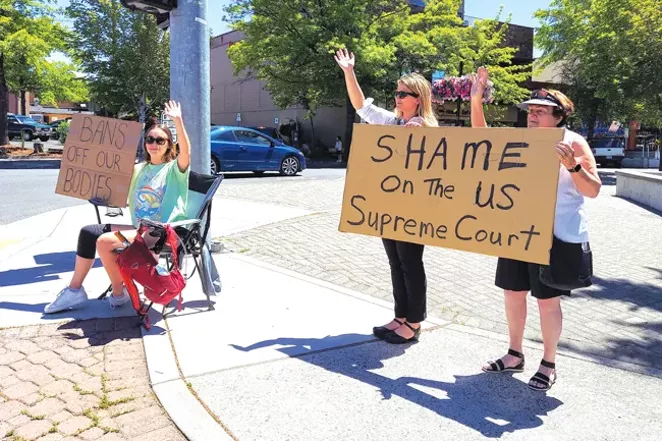 Lindsey Narkchareon, Ariel Vee, and Gina Vee, from left to right, protested the reversal of Roe v. Wade Friday in downtown Bend. - RENÉE ALEXANDER