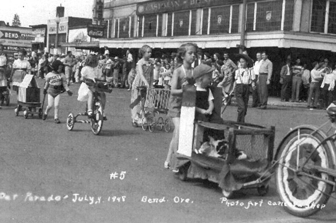 Pet Parade; Fourth of July, 1948; Bend; Photo Art Camera Shop; #5; Children with pets and on tricycles in parade; one child has a shirt that reads "Mighty Mouse." - COURTESY  DESCHUTES COUNTY HISTORICAL