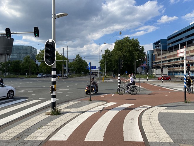 A typical busy street in Amsterdam, with the red road indicating the bike route, complete with its own traffic lights. - NICOLE VULCAN