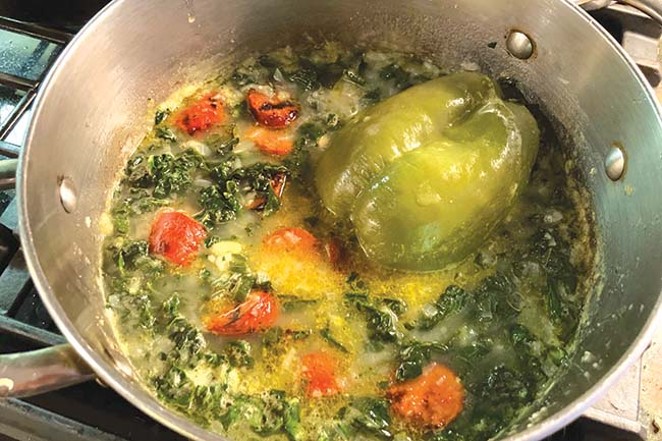 Caldo verde simmering with the author's secret ingredient. - ARI LEVAUX