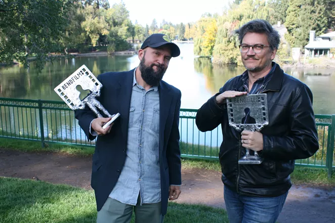 Festival Director Todd Looby and Festival Programmer Erik Jambor get silly with BendFilm's award statues during our interview in Bend's Drake Park. - NICOLE VULCAN