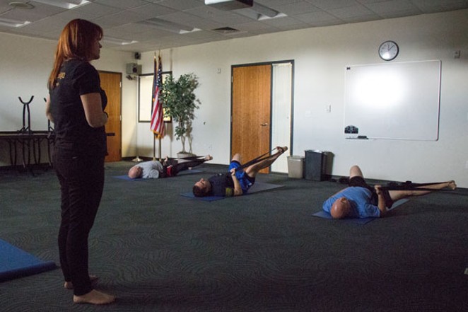 Christina Davenport leads Bend patrol officers through noontime yoga. - KEELY DAMARA