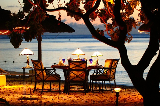 A candle-lit dinner overlooking the water. - PIXABAY