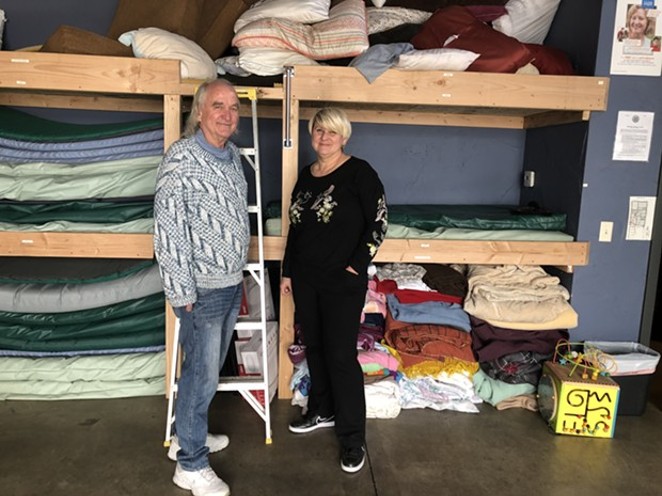 Larry Kogovsek and Sally Pfeifer stand in front of the newly-constructed bunk beds in the Sagewood Sanctuary, located inside Pfeifer & Associates on NW Greenwood Ave. Sagewood is currently the only approved emergency shelter in Bend. - NICOLE VULCAN
