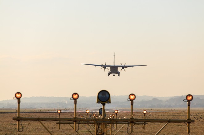A plane lands using the airport's navigational system. - CANSTOCKPHOTO.COM