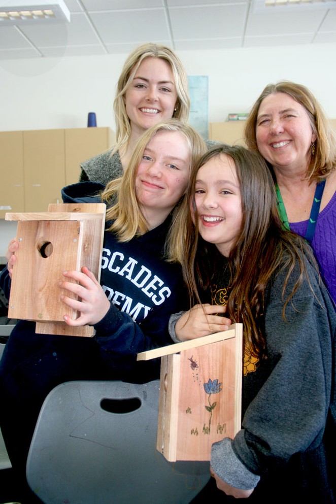 Students Katie and Sophia show their nesting boxes. Behind them, from left, are Michelle van Hilten, program administrator for Think Wild, and Anne-Marie Eklund, science teacher at Cascades Academy. - JIM ANDERSON