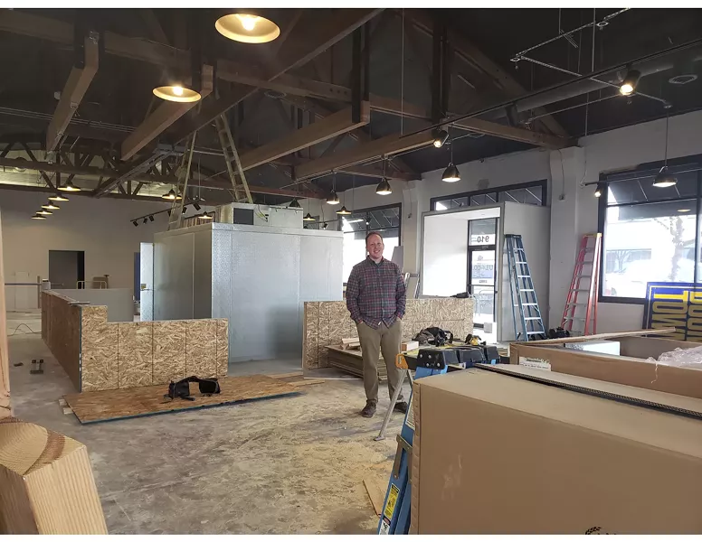 John Heylin stands in the space that is slowly being transformed into Unofficial Logging Co., Bend's first hatchet-throwing bar. - CAYLA CLARK