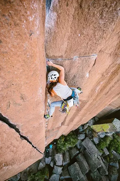 Rock climber Lizzy VanPatten scales the side of a cliff. - NICOLE WASKO