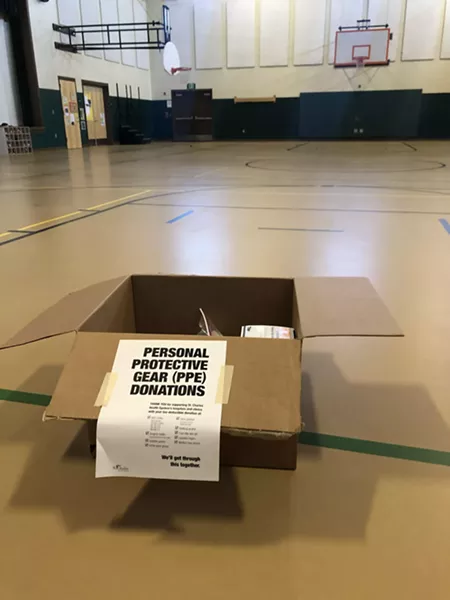 A box sits ready for donations Friday in the gym/cafeteria of Ensworth Elementary in Bend. Drop locations are located at grab-and-go lunch sites around Central Oregon. - NICOLE VULCAN