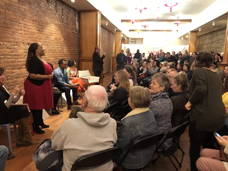 McCalpine addresses a packed room at the first Love Your Neighbor event at At Liberty Arts in downtown Bend in February 2020. - NICOLE VULCAN