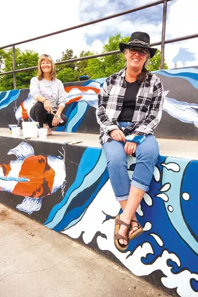 Artists Tracy Thille and Kris Cranston at the Redmond skate park mural. - DARRIS HURST