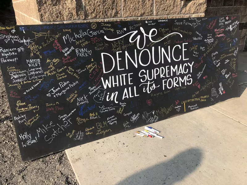 Members of Clergy for Justice brought this sign down to the event at Pilot Butte and people from both the pro-Trump group and BLM signed it throughout the day. - COURTNEY CHRISTENSON