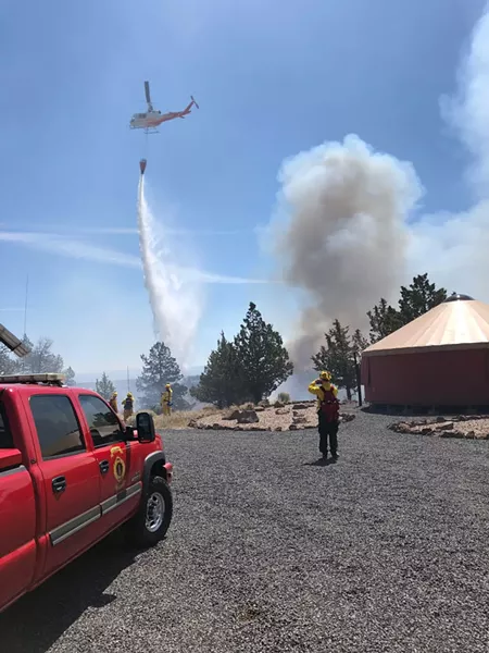 A helicopter drops water on the Graham fire near Lake Billy Chinook. - SUBMITTED
