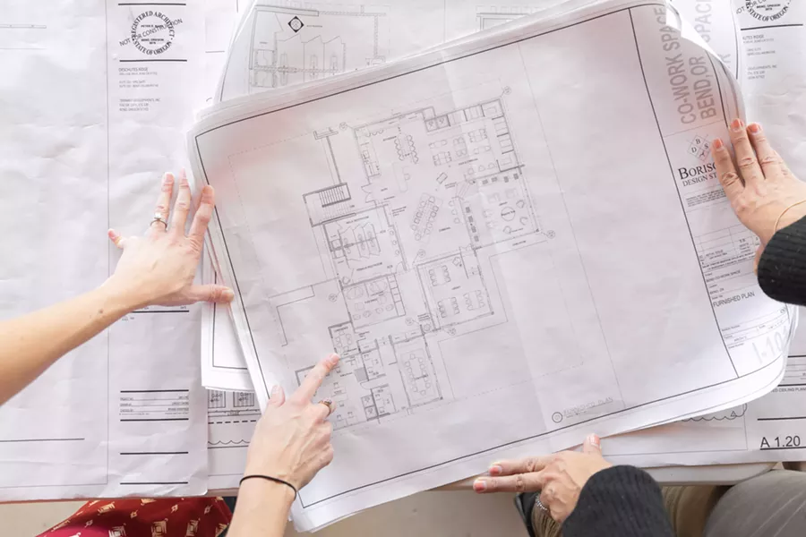 Douglass reviews plans for her new co-working space, which will be one of several already in operation in Bend. - ANNA JACOBS – UNION CULTURE