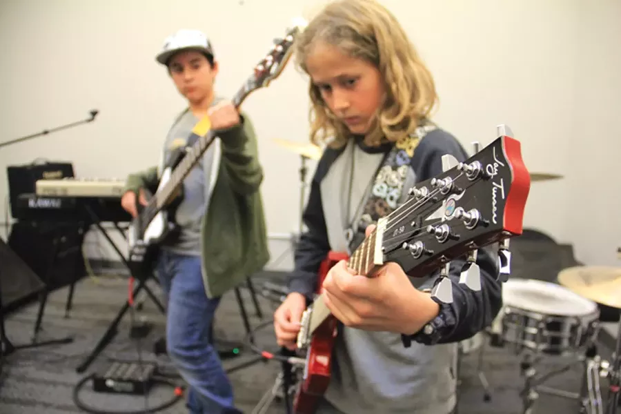 Roman finger picks "Sunday Bloody Sunday" by U2 with back up from bassist, Andres. - K.M. COLLINS