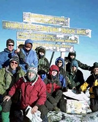 Rasmussen on the summit of Uhuru Peak in Tanzania. Africa&#39;s highest point and the world&#39;s highest free-standing mountain.