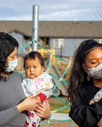 Dyana Osegueda and Raisa Hisatake, two interventionists at MountainStar Family Relief Nursery, play with infants at the Bend center. Young children spend half-days at MountainStar facilities, up to several days a week.