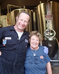 Homebrewer Nancy Noll, right, gets a congratulatory hug from fellow brewer Patio.