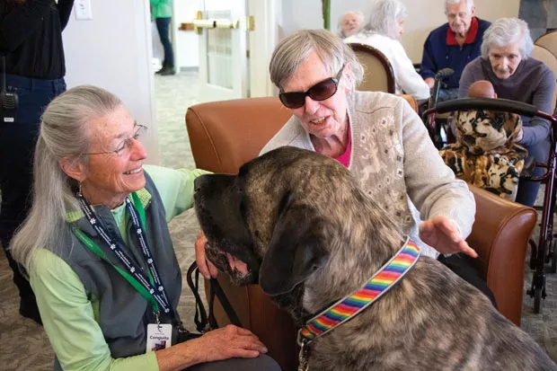 Jennifer Horsman and her therapy dog, Hobie, greet Aspen Ridge Memory Care resident Joan Wray on Friday, march1, 2019. - KEELY DAMARA