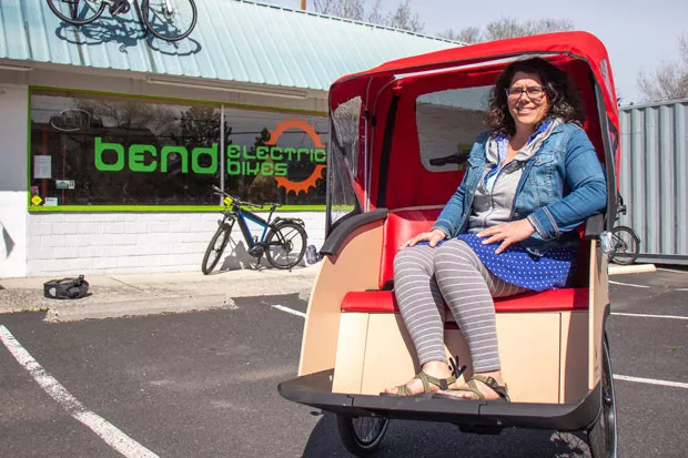 Courtney sits in a trishaw, or bike taxi, that she recently purchased for the Bend chapter of Cycling Without Age. - KEELY DAMARA