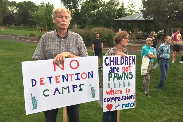 Bend residents take part in the recent Lights For Liberty: A Vigil to End Human Concentration Camps, held in Orchard Park. - GREGG HEACOCK