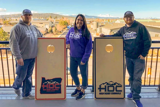 From left, Chris and Renee Yocum and Dustin Close are all high on cornhole. - BEN BAKER PRODUCTIONS