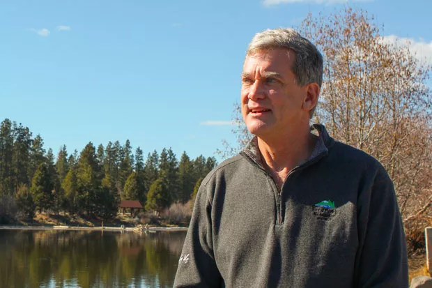 Bend Park and Recreation District Executive Director Don Horton stands on the banks of the Deschutes River near his office at Riverbend Park. - LAUREL BRAUNS