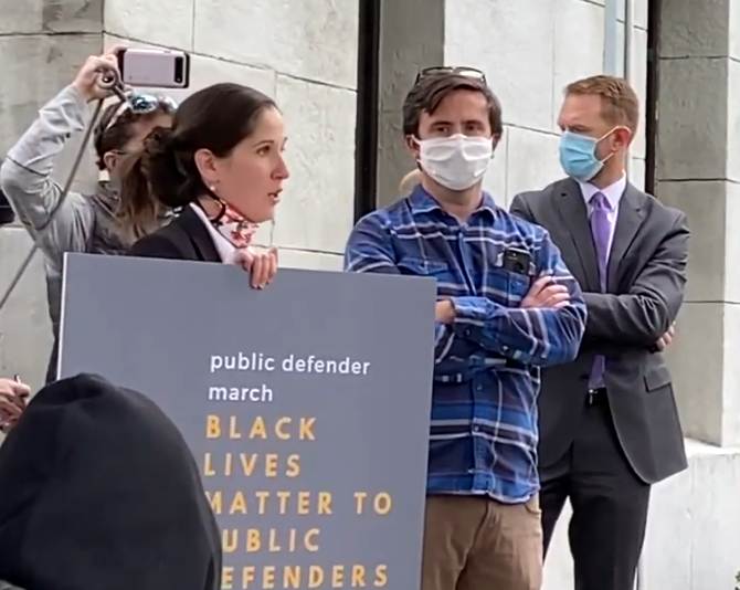 Public defenders from across the U.S. participated in a national Black Lives Matter protest on Monday, June 8 at noon. Here in Bend, Kat Griffith (above) was one of the local lawyers who organized a spectacle during District Attorney John Hummel’s press conference. - LAUREL BRAUNS
