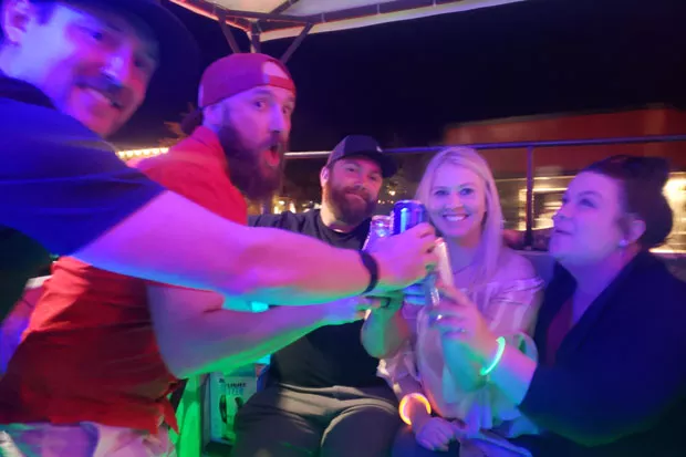 A group of happy strangers clinking White Claws to a night well spent. - CAYLA CLARK