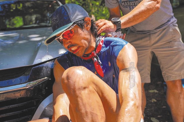 Mario Mendoza, Jr. cools off during the &quot;Western States 100&quot; race where temperatures were recorded reaching 104 degrees. He finished 16th out of 299 people. - PAUL NELSON