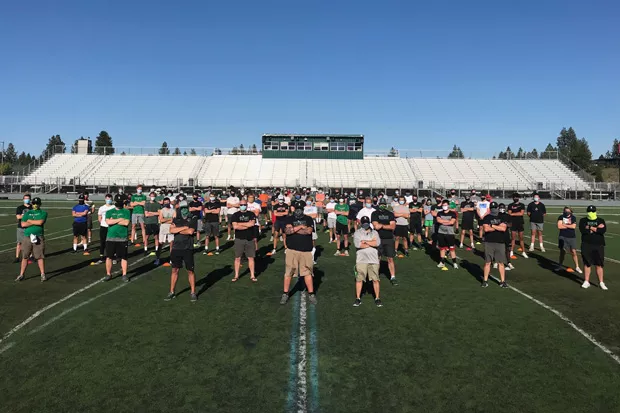 The Summit High School football team stands together to promote wearing a mask while working out. Although the football season is scheduled to start Feb. 22, the school's teams are already training in the weight room and doing conditioning exercises. - COURTESY SUMMIT FOOTBALL TEAM