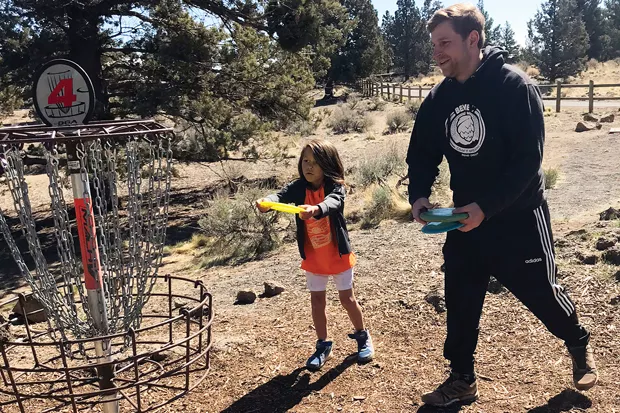 Father and son, John Bellman and Nyjah Sulesky enjoy time together playing Disc Golf at Pine Nursery Park. - NICOLE BLUME