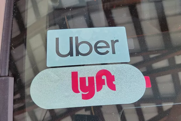 An Uber and Lyft Sticker on Devin Linker’s car. Linker said he likes that with Uber and Lyft he can set his own schedule and work when he wants to. - DEVIN LINKER