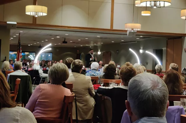 National Pulse Editor in Chief Raheem Kassam stands center stage in Bend Golf Club's dining hall on Wednesday, Aug. 25, for a sold-out fundraiser. - JACK HARVEL