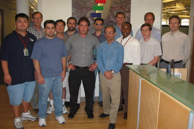 Chuck Allen stands with coworkers years after many of them survived the September 11 attacks. - COURTESY OF CHUCK ALLEN.