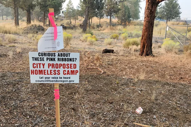 A sign marks the site of a proposed managed camp for houseless people on Ninth Street, and encourages people to get in touch with the City to share their thoughts.. - JACK HARVEL