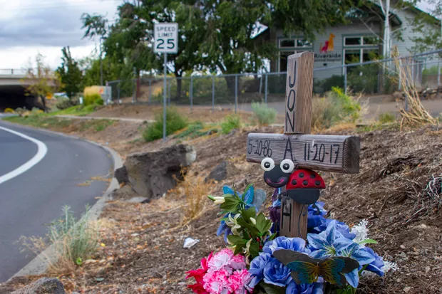 A memorial for Jonathan Adams, who was struck and killed by a Fed-Ex semi-tractor trailer in the intersection just east of NW Wall Street as the vehicle was turning right from NW Wall Street onto NW Olney Avenue on Nov. 20, 2017. - ELLA TAFT