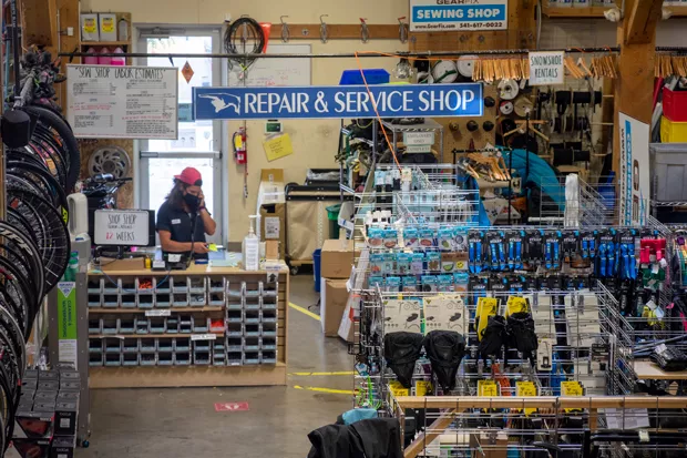 Nico Brilmyer works the repair station at Gear Fix in Bend. - TREVOR BRADFORD